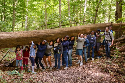 Posing under a big log at Camp Friedenswald