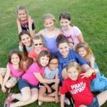Girls cabin posing for picture with their counselor at Camp Friedenswald