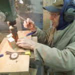 J.O. Augspurger assists with a woodworking project