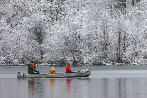 family canoeing in winter