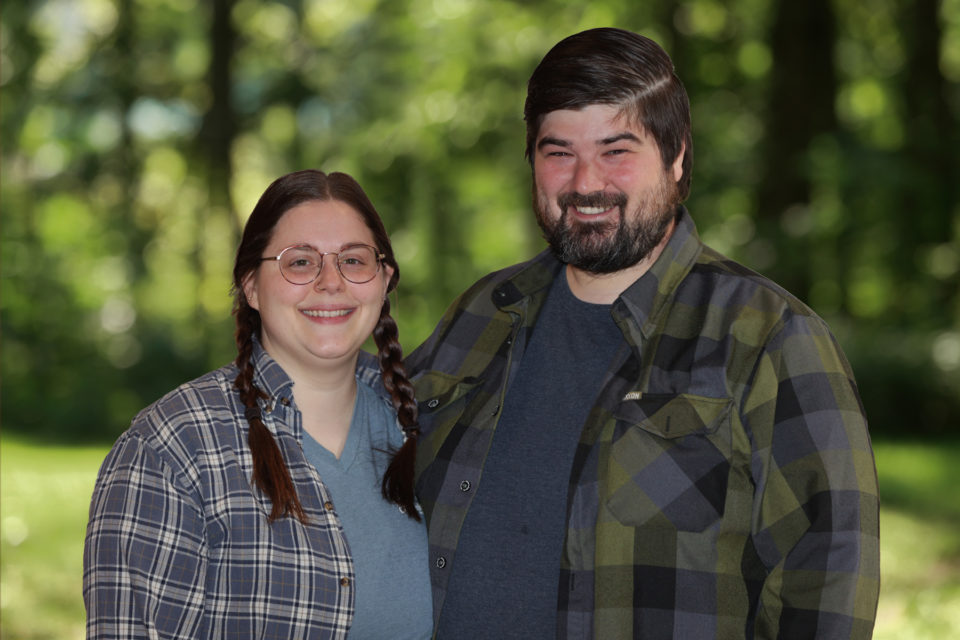 Two new staff (Jeremy and Janessa) pictured standing outside