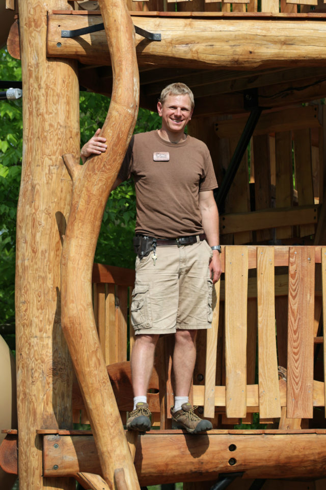 Jonathan standing beside completed playground