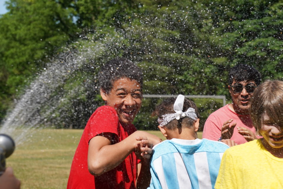 boy gets sprayed with water