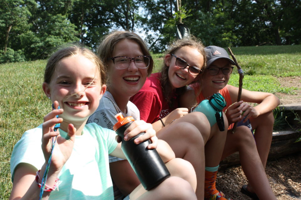 Four campers sitting on hill